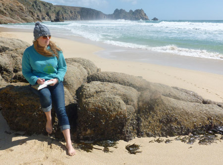 Emylia Hall sitting on the beach