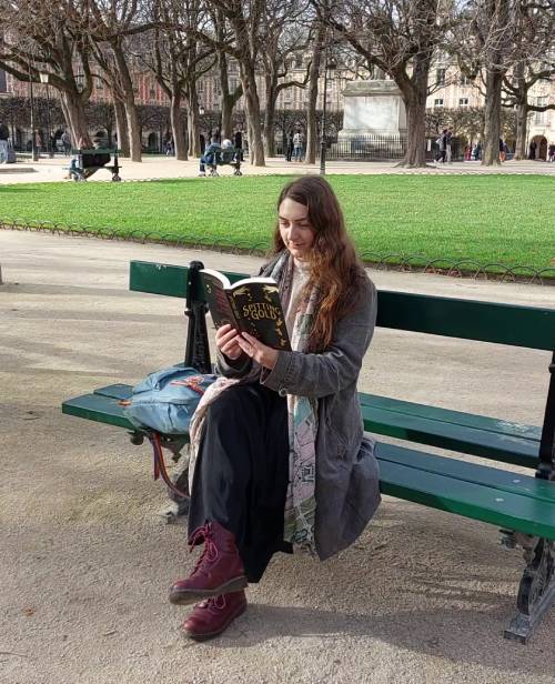 Carmella reading Spitting Gold in the Place des Vosges